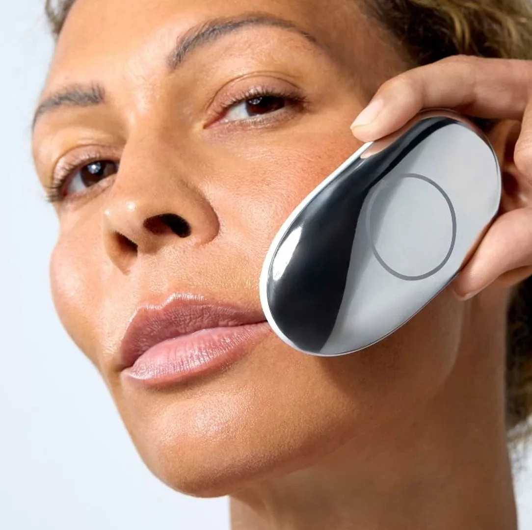 The ZIIP Halo microcurrent device in use on a woman's cheek